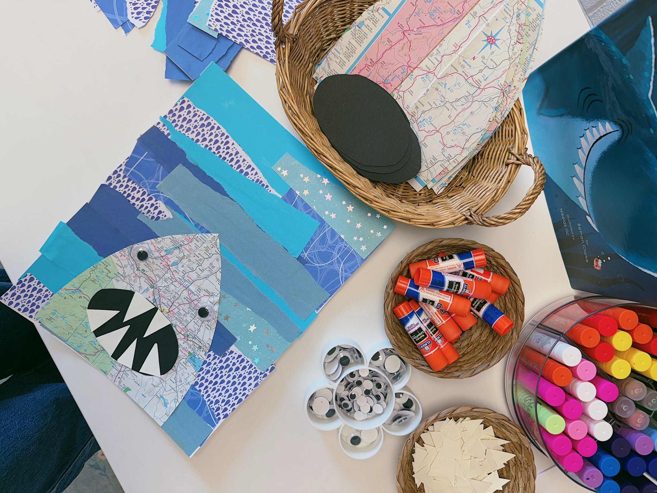 STUDIO_HERO.JPG — wide interior shot during an afternoon class, natural light, kids at craft tables, Jalesa in frame